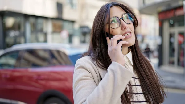 Young Beautiful Hispanic Woman Talking Smartphone Serious Expression Street — Stock Photo, Image