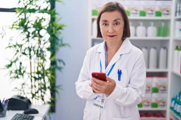 Middle Age Woman Pharmacist Using Smartphone Working Pharmacy — 스톡 사진