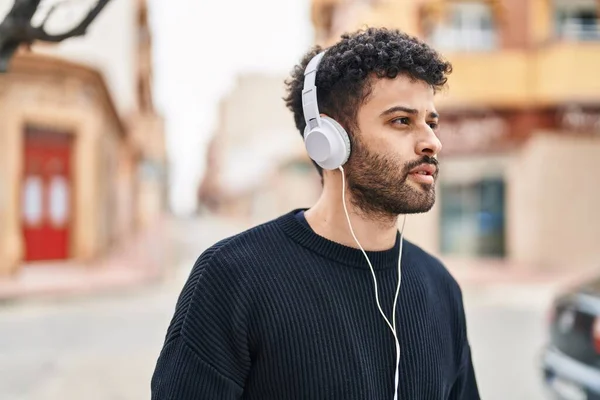 Young Arab Man Listening Music Relaxed Expression Street — Stockfoto