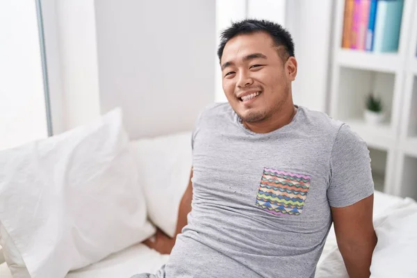 Young Chinese Man Smiling Confident Sitting Bed Bedroom — Stok fotoğraf