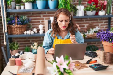 Çiçekçide videolu görüşme yapan güzel İspanyol kadın.