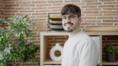 Young hispanic man business worker smiling confident standing at office