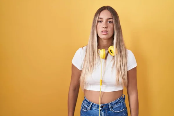 Young Blonde Woman Standing Yellow Background Wearing Headphones Looking Sleepy — Stock Photo, Image