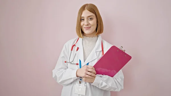 Young Blonde Woman Doctor Smiling Confident Holding Clipboard Isolated Pink — Stock Photo, Image