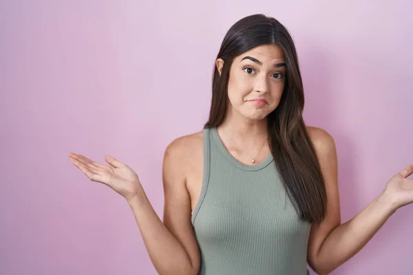 Hispanic Woman Standing Pink Background Clueless Confused Expression Arms Hands — Stock Photo, Image