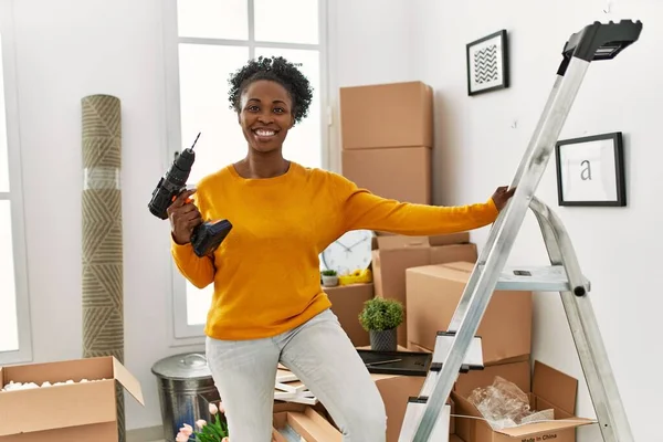 African American Woman Holding Drill Standing Ladder New Home — Stock Photo, Image