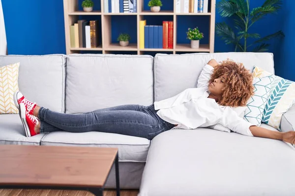 stock image African american woman lying on sofa sleeping at home