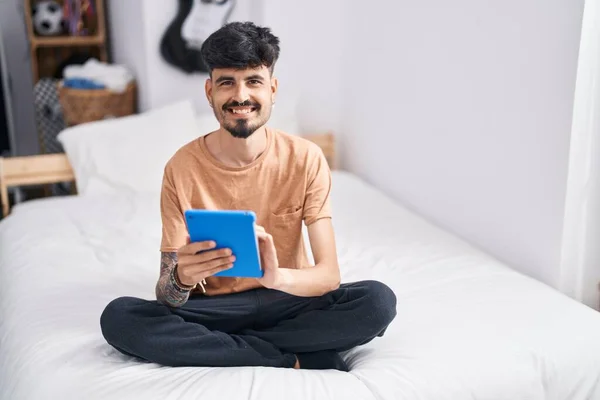 Young Hispanic Man Using Touchpad Sitting Bed Bedroom — Stok fotoğraf