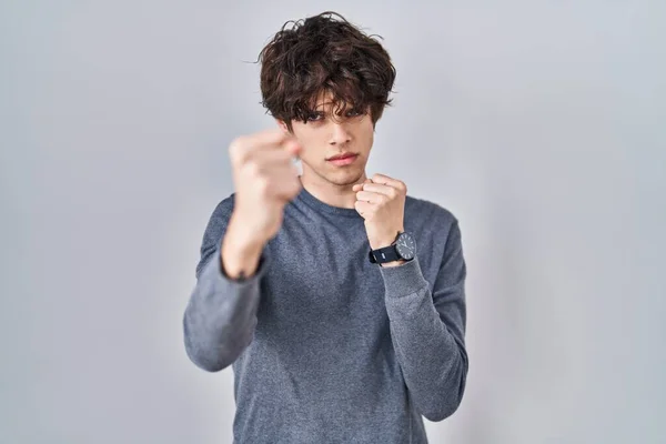 Young Man Standing Isolated Background Ready Fight Fist Defense Gesture — Zdjęcie stockowe