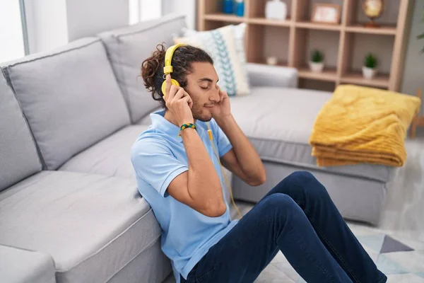 Young Hispanic Man Listening Music Sitting Floor Home —  Fotos de Stock