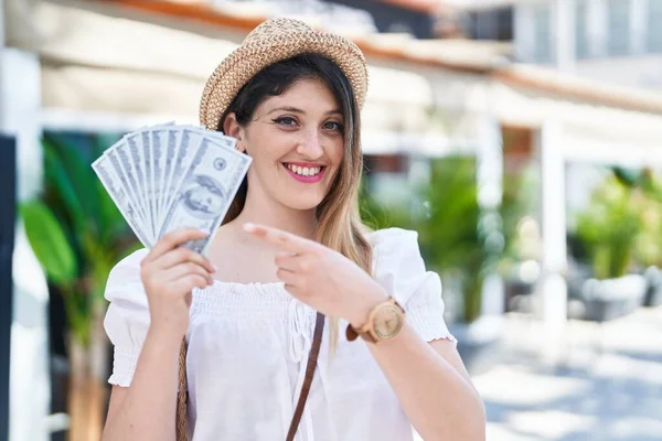 Young Brunette Woman Holding Dollars Banknotes Smiling Happy Pointing Hand — Stock Photo, Image