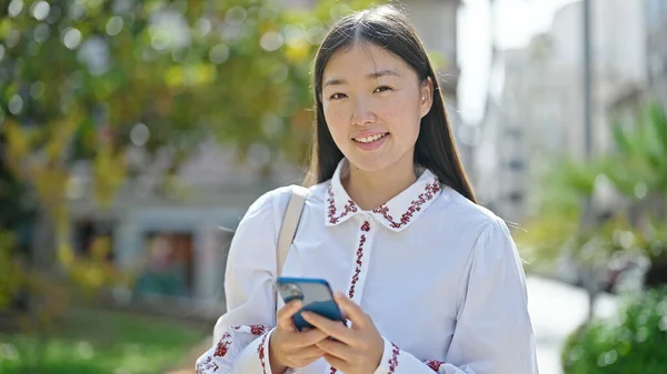Młoda Chinka Korzystająca Smartfona Uśmiechnięta Parku — Zdjęcie stockowe