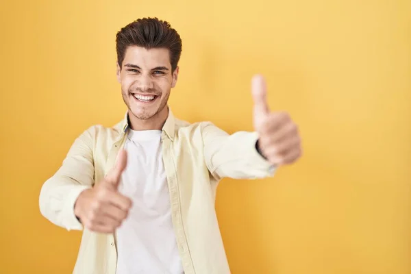 Young Hispanic Man Standing Yellow Background Approving Doing Positive Gesture — Foto de Stock