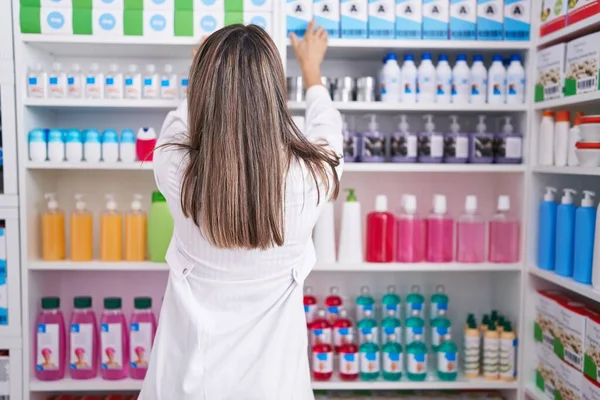Young Beautiful Hispanic Woman Pharmacist Holding Product Shelving Pharmacy — 스톡 사진