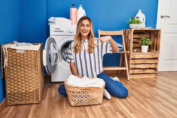 Young Blonde Woman Doing Laundry Home Pointing Finger One Self — Stock Photo, Image