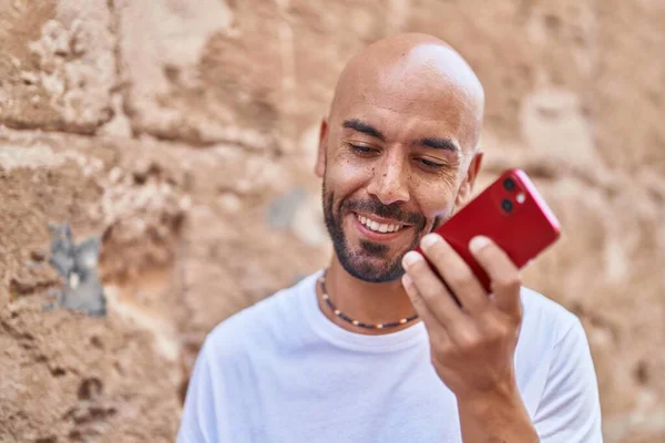Young Bald Man Smiling Confident Talking Smartphone Isolated Stone Background — Stock Photo, Image