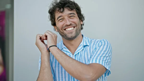 Young Hispanic Man Smiling Confident Doing Heart Gesture Hands Street —  Fotos de Stock
