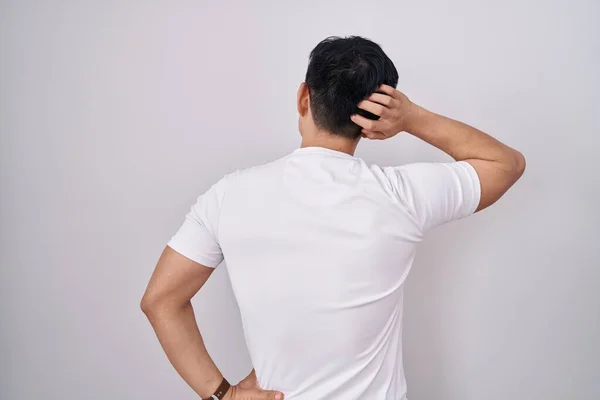 Young Asian Man Standing White Background Backwards Thinking Doubt Hand — Stock Photo, Image