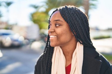 African american woman smiling confident looking to the side at street