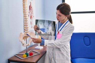 Rehabilitasyon kliniğinde ciddi yüzü olan genç sarışın fizyoterapist.