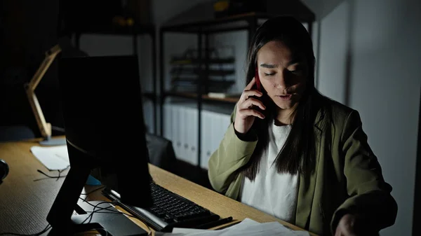 stock image Young beautiful hispanic woman business worker using computer talking on smartphone at office