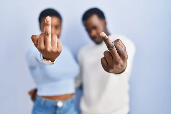 Young African American Couple Standing Blue Background Showing Middle Finger — стоковое фото