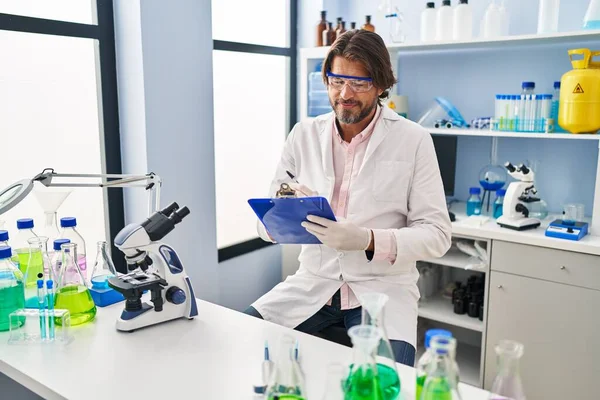 Middle Age Man Scientist Smiling Confident Writing Document Laboratory — Stockfoto
