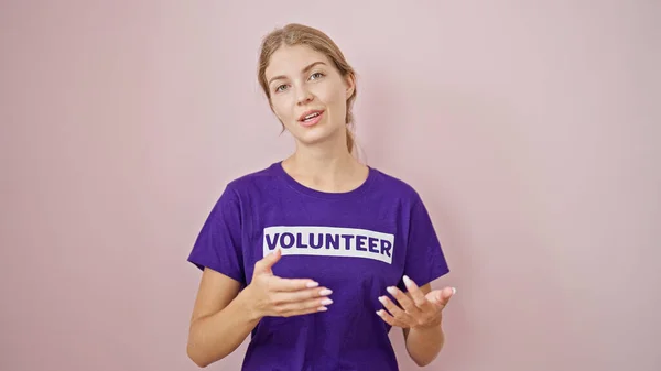 Νεαρή Ξανθιά Εθελόντρια Μιλώντας Απομονωμένο Ροζ Φόντο — Φωτογραφία Αρχείου