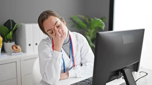 若い白人女性医師は診療所で働くコンピュータを使って強調した — ストック写真