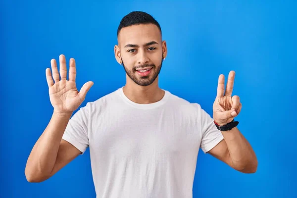Young Hispanic Man Standing Blue Background Showing Pointing Fingers Number — Fotografia de Stock