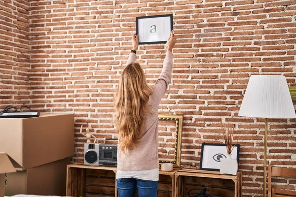 Young Woman Hanging Picture Wall New Home — Stock Photo, Image
