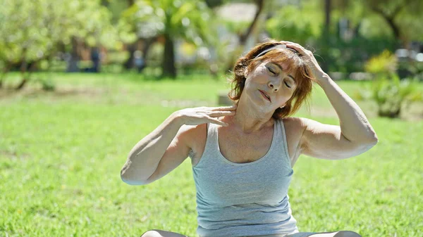 Middle Age Woman Stretching Head Sitting Yoga Mat Park — Stock Photo, Image