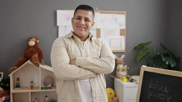 Young Hispanic Man Preschool Teacher Smiling Confident Standing Arms Crossed — Stock Photo, Image