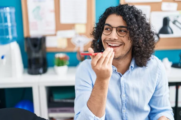 stock image Young latin man business worker talking on smartphone working at office