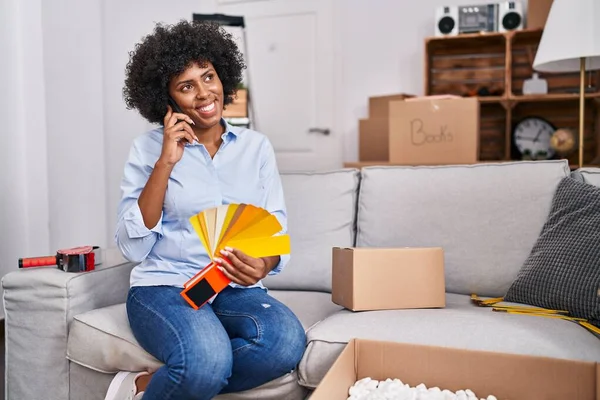 African American Woman Talking Smartphone Holding Color Test New Home — Stockfoto