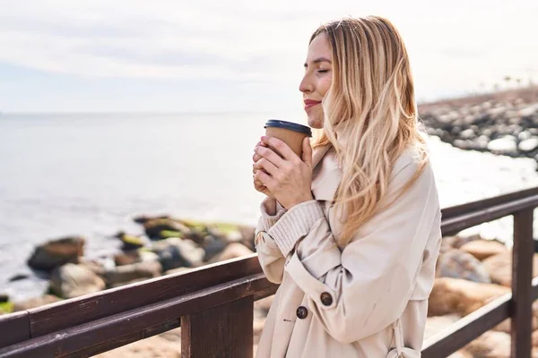Young Blonde Woman Smiling Confident Drinking Coffee Seaside — Stock Photo, Image
