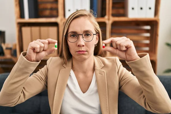 Young Blonde Woman Holding Pills Therapy Skeptic Nervous Frowning Upset — Stok fotoğraf