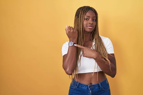 Sarı Arka Planda Örülü Saçları Olan Afrikalı Amerikalı Kadın Acele — Stok fotoğraf