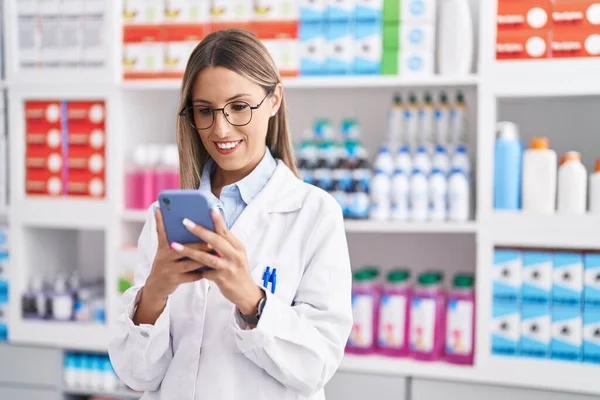 Young Beautiful Hispanic Woman Pharmacist Using Smartphone Working Pharmacy — Stock Photo, Image