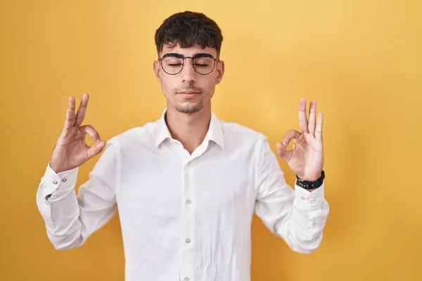 Sarı Arka Planda Duran Genç Spanyol Adam Rahatlamış Parmaklarıyla Meditasyon — Stok fotoğraf
