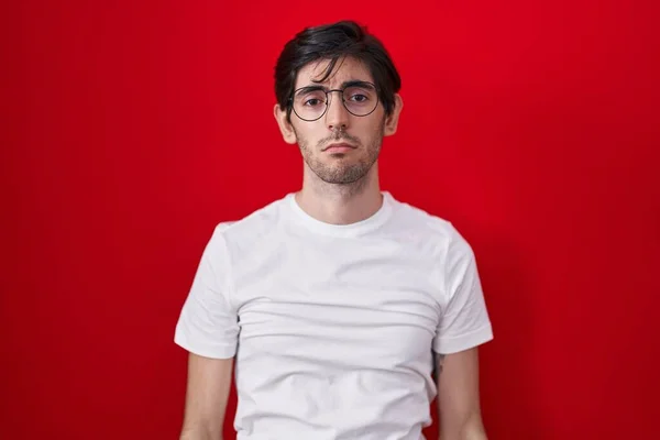 Young Hispanic Man Standing Red Background Depressed Worry Distress Crying — Stockfoto