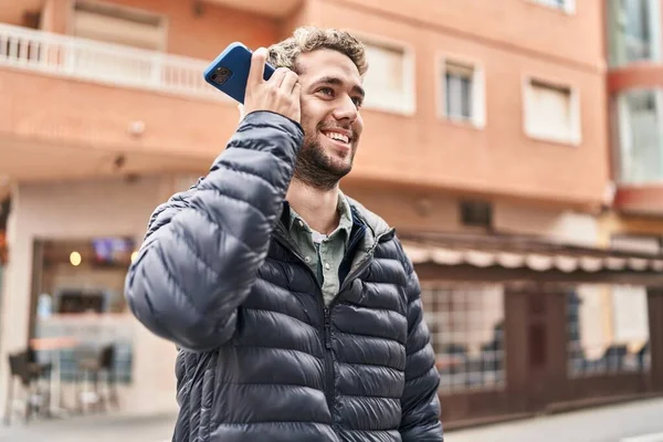 Young Man Miling Confident Listening Audio Message Smartphone Street — Stockfoto