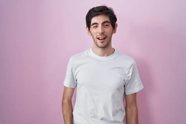 Young Hispanic Man Standing Pink Background Winking Looking Camera Sexy — Stockfoto