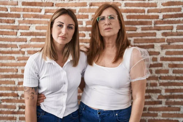 Hispanic Mother Daughter Wearing Casual White Shirt Relaxed Serious Expression — Zdjęcie stockowe