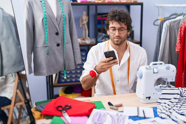Young Hispanic Man Tailor Using Smartphone Clothing Factory — Foto Stock