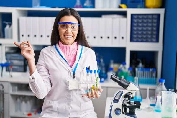 Young Brunette Woman Working Scientist Laboratory Smiling Happy Pointing Hand —  Fotos de Stock