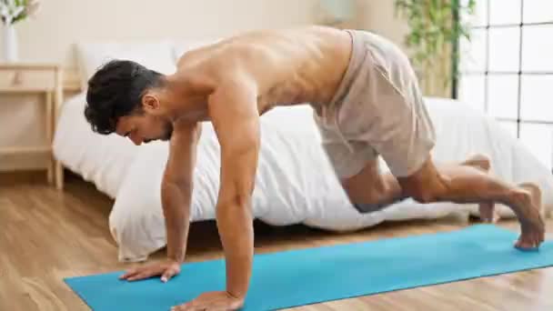 Young Hispanic Man Training Core Exercise Bedroom — Stock Video