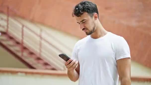 Young Hispanic Man Using Smartphone Winner Gesture Street — 비디오