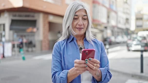 Středního Věku Šedovlasá Žena Pomocí Smartphone Úsměvem Ulici — Stock video