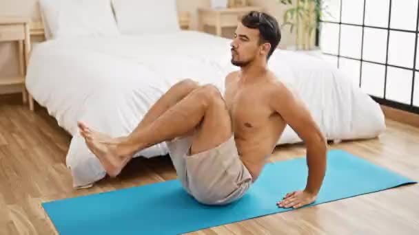 Young Hispanic Man Training Abs Exercise Bedroom — Stock Video
